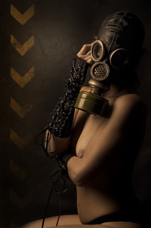 Woman with gas mask in a grunge backgroundの写真素材