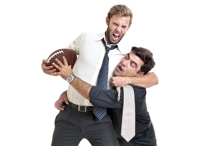 Businessmen playing rugby isolated in whiteの写真素材