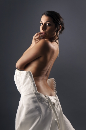 Beautiful bride dressing isolated in a dark backgroundの写真素材