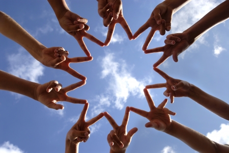 Hands together against the sky