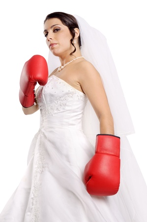 Beautiful bride posing with boxing gloves の写真素材