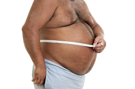 Large man belly with measuring tape isolated in whiteの写真素材