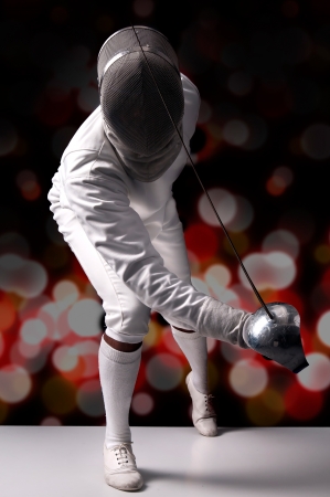 Male fencer isolated in a dark background