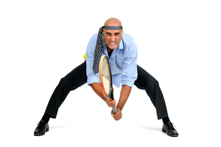 Businessman playing tennis isolated in whiteの写真素材