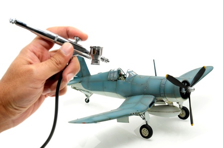 Model kit of an WWII american fighter with modelist hand