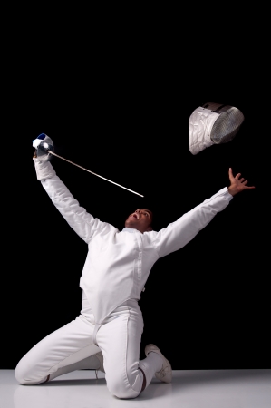 Male fencer isolated in a dark background