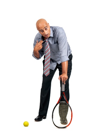 Businessman playing tennis isolated in whiteの写真素材