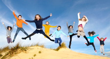Group of children jumpng outdoorsの写真素材