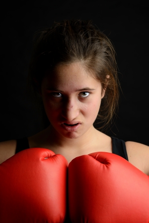 Young girl boxer posing with glovesの写真素材