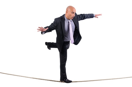 Businessman walking a rope in despair