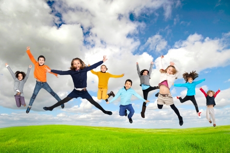 Group of children jumpng outdoorsの写真素材