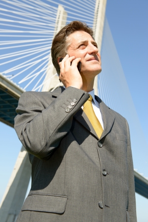 Businessman with cellphone outdoorsの写真素材