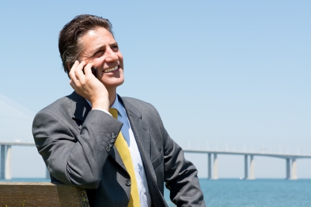 Businessman outdoors with cellphoneの写真素材