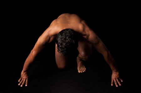 Handsome and muscular man in dark backgroundの写真素材