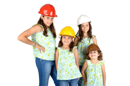 Group of young girls posing with costruction workers hatsの写真素材