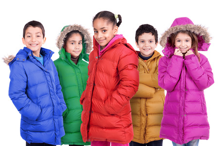 Group of children posing in colorful winter coats isolated in whiteの写真素材