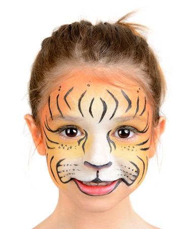 Beautiful young girl with face painted like a tigerの写真素材