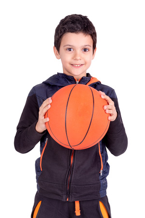 Young boy posing with a basketball ball isolated in whiteの写真素材