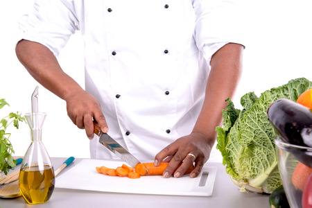 Male chef with fruits and vegetables on table, isolated on white backgroundの写真素材
