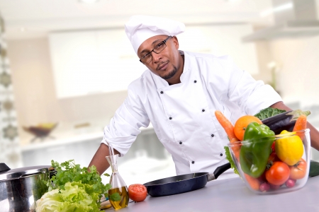 Male chef with fruits and vegetables cookingの写真素材