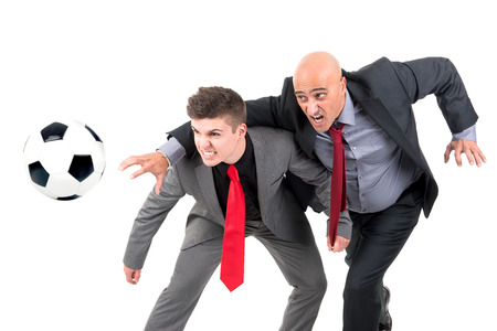 Businessmen playing soccer ball isolated in whiteの写真素材