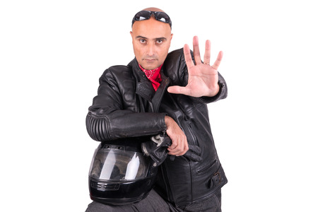 Biker in leather jacket with helmet isolated in whiteの写真素材