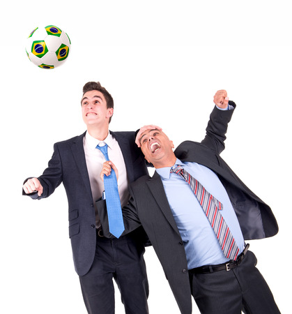 Businessmen playing soccer isolated in whiteの写真素材
