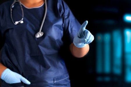 Doctor pointing in a dark background