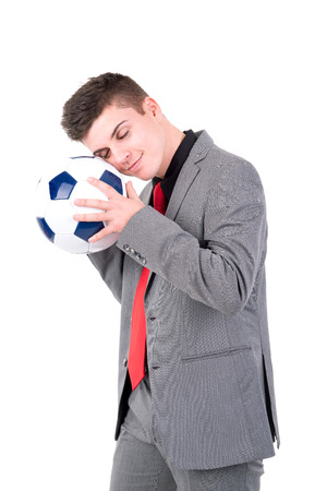 Businessman holding soccer ball isolated in whiteの写真素材