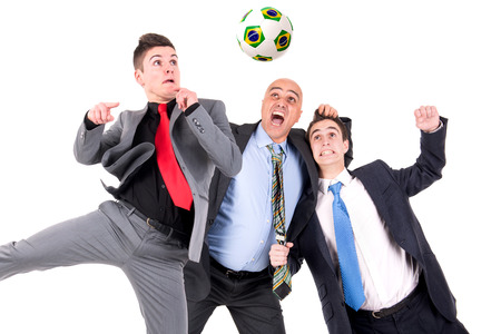 Businessmen playing soccer isolated in whiteの写真素材