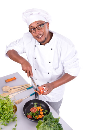 Male chef with fruits and vegetables cookingの写真素材
