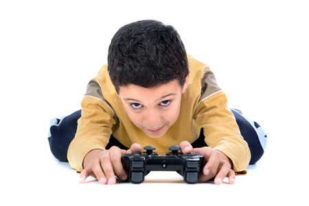 Boy playing video games isolated in white