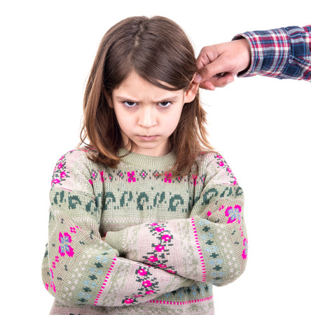 Young girl being punished with ear pullingの写真素材