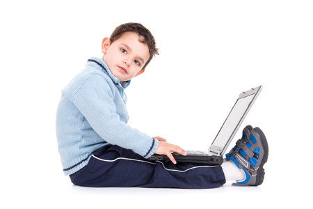 Young boy with laptop computer isolated in white