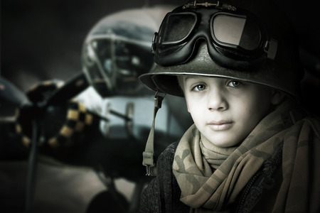 Young boy soldier in a dark backgroundの写真素材