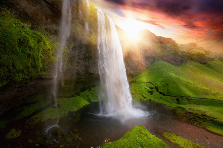 Beautiful and dramatic sunset in Seljalandsfoss waterfalls, Icelandの写真素材