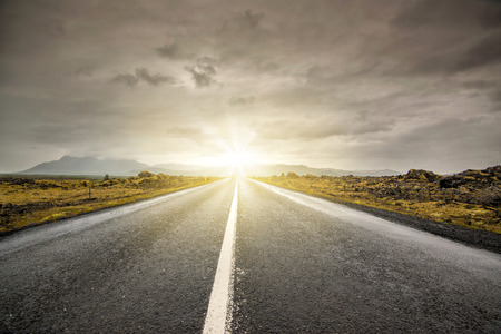 Empty road with cloudy skies in wild Icelandの写真素材