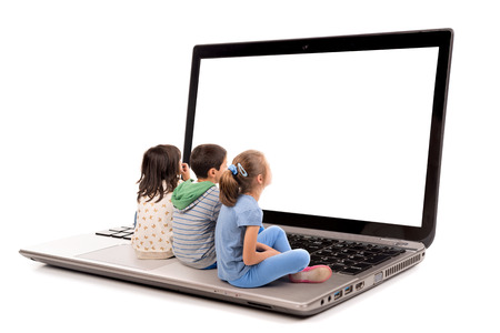Group of young children in a laptop computer keyboard looking at the screenの写真素材