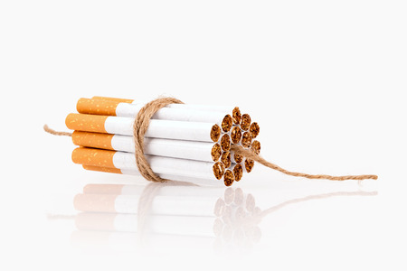 Cigarettes together in dinamite style with fuse, isolated in white