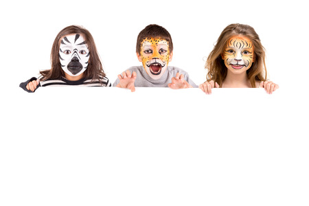 Children's group with face-paint over a white boardの写真素材