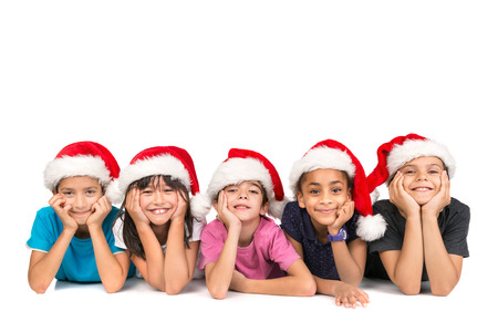 Group of children with Santa's hat posing isolated in whiteの写真素材