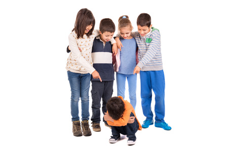 Group of children bullying an isolated childの写真素材