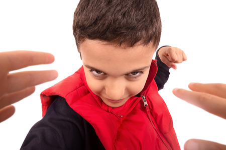 Young boy bullying another isolated in whiteの写真素材