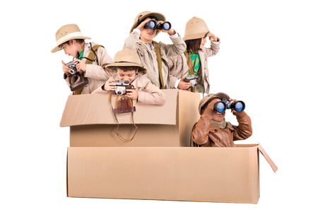 Children's group in a cardboard box playing safariの写真素材