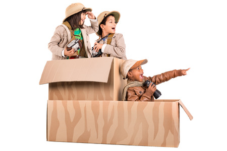 Children's group in a cardboard box playing safariの写真素材