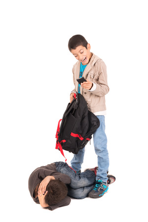 Boy bullying and stealing from a smaller one isolated in whiteの写真素材