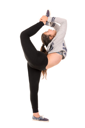 Girl doing exercises isolated in whiteの写真素材