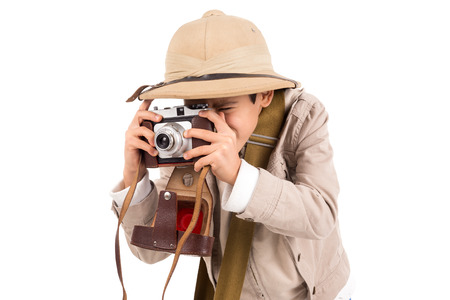 Young boy with camera playing Safari isolated in whiteの写真素材