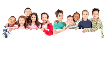 Group of children with a white board isolated in whiteの写真素材