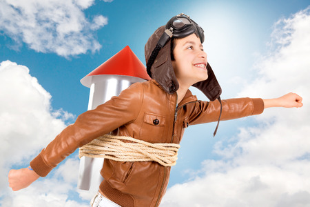 Young boy with home made rocket ready for adventureの写真素材